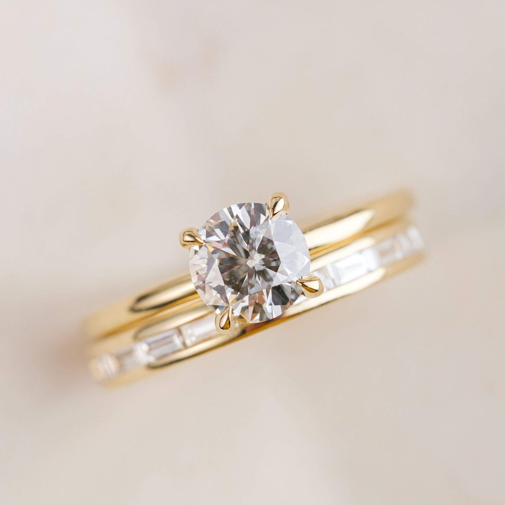 14k yellow gold solitaire diamond ring paired with 14k yellow gold baguette diamond eternity band