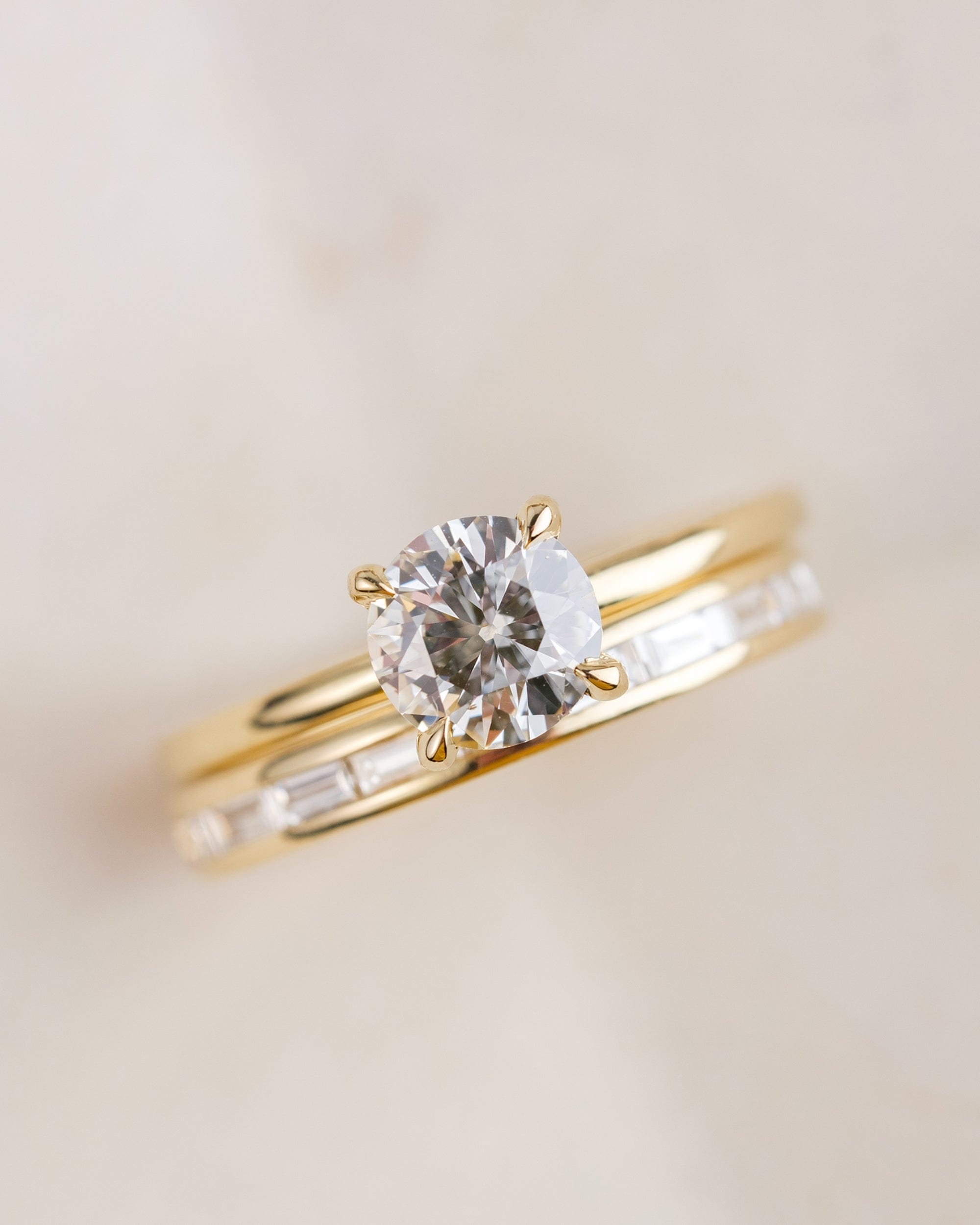 14k yellow gold solitaire diamond ring paired with 14k yellow gold baguette diamond eternity band