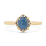 14k yellow gold diamond halo engagement ring with a opalescent blue cushion sapphire