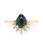 14k yellow gold engagement ring with teal green sapphire and a half-halo of diamonds