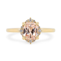 14k yellow gold halo engagement ring with peach cushion cut sapphire