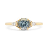 A stormy gray-blue sapphire engagement ring with 6 accent diamonds set in 14k yellow gold