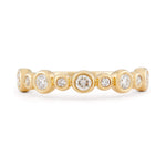 Diamond and 14k yellow gold bezel set wedding band 