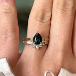 Video of baguette diamond wedding band and 14k yellow gold engagement ring with teal green sapphire and a half-halo of diamonds