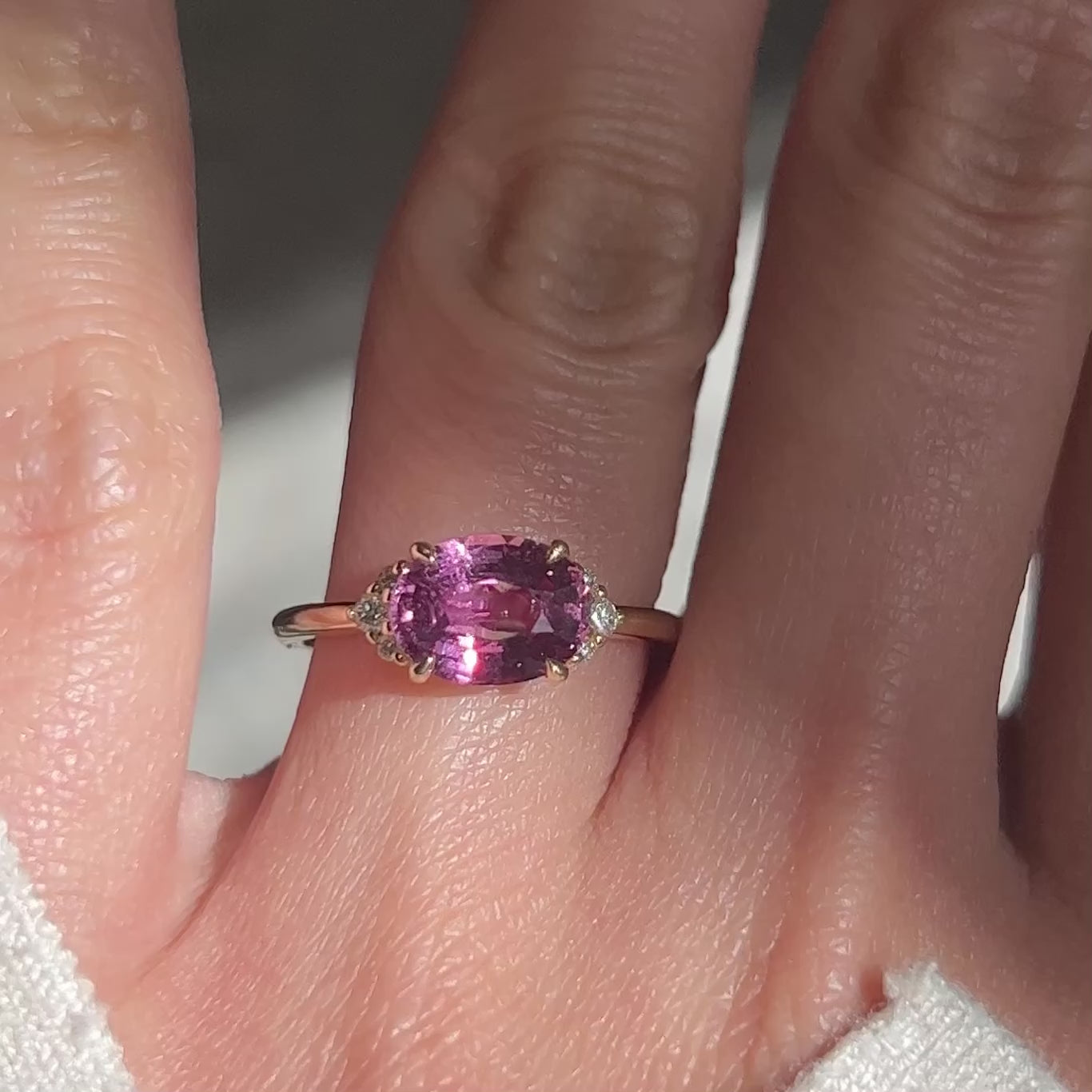 Video of 14k yellow gold engagement ring with pink oval-cut sapphire and diamonds