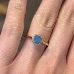 Video of a 14k yellow gold diamond halo engagement ring with a opalescent blue cushion sapphire